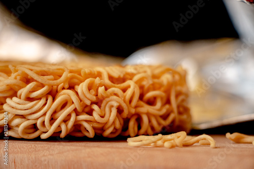 Uncooked Raman Noodle. The dry instant noodles are in the bag or cup, with flavoring powder and seasoning oil. The main ingredients are flour, starch, salt, sodium carbonate.