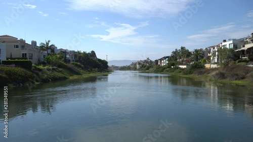 Beautiful view of Marina del Rey lagoon. Channel with ocean water. Private houses on both sides of shore. Warm Sunny Day in Los Angeles California.