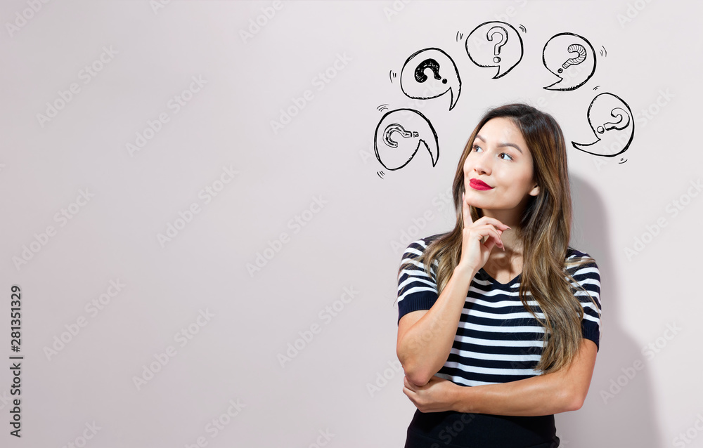 Question marks with speech bubbles with young businesswoman in a thoughtful face Question marks with speech bubbles with young businesswoman in a thoughtful face