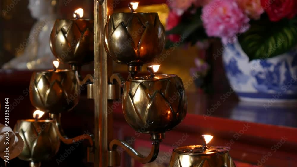 Flame from burning oil candle lamp in buddhist temple. Closeup. 4k Flame from burning oil candle lamp in buddhist temple. Closeup. 4k