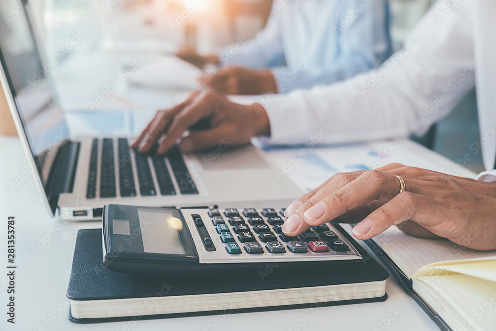Administrator business man financial inspector and secretary making report calculating balance. Internal Revenue Service checking document. Audit concept Administrator business man financial inspector and secretary making report calculating balance. Internal Revenue Service checking document. Audit concept