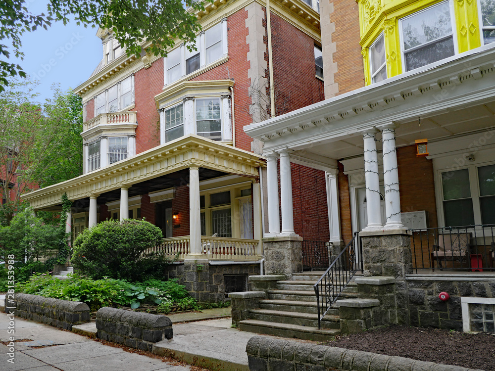 Obraz premium large old detached brick houses with front porches, converted to flats