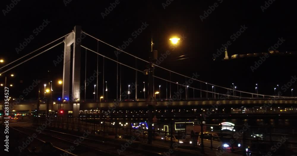 Pan shot of the Elisabeth Bridge at night over the Danube river in Budapest. Pan shot of the Elisabeth Bridge at night over the Danube river in Budapest.