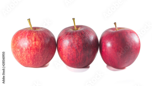 Three ripe fresh red apples standing on white background