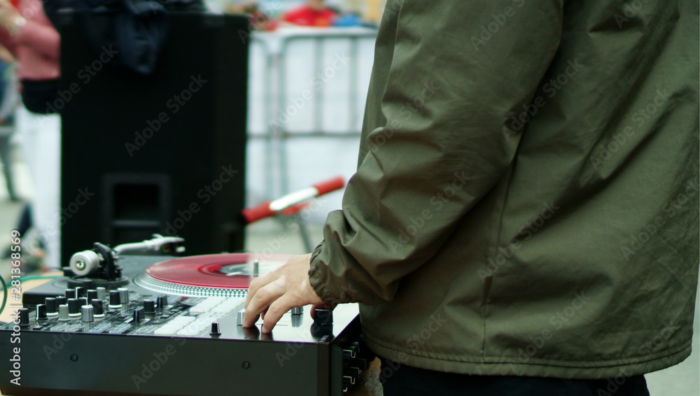DJ plays music in the city street