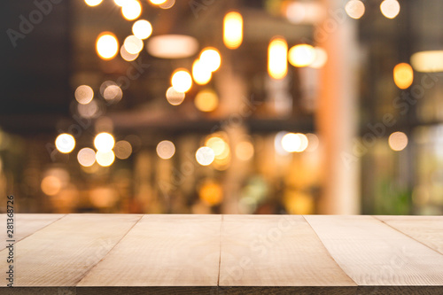 Blur background of coffee shop or restaurant interior background with empty wood table.