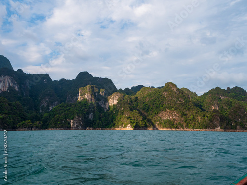 Scenic landscape of boat view in the big river and reservoir dam with mountain and nature forest © Kaikoro