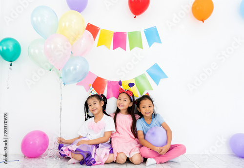 Group of happy young Asian children Cheerful with Balloons colorful and smiling fun celebration party in room. Kid and friends in international preschool Room, Childhood, holidays, friendship concept