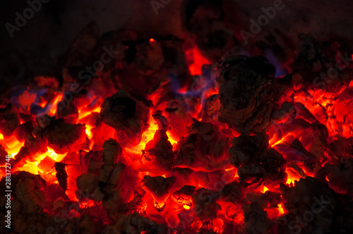 Nature fire flames on black background. Fire burning firewood burning fire flame texture in the fireplace charcoal. Concepts: fire, BBQ, barbeque, still life