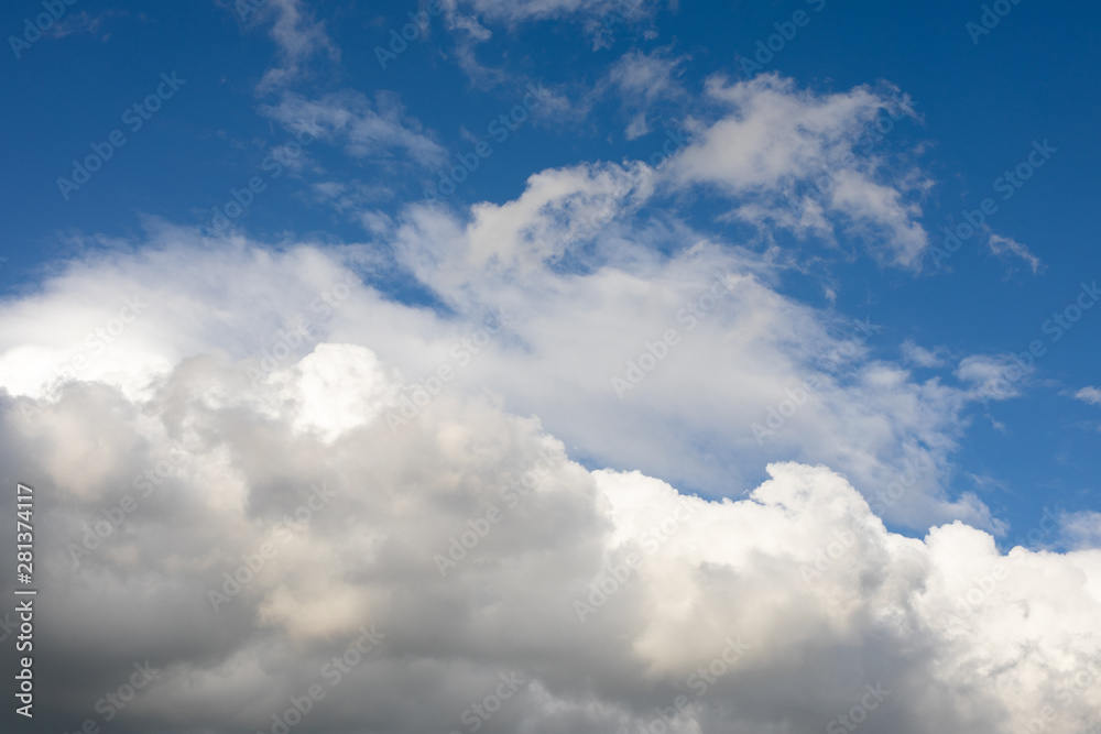 Blue sky background with clouds.Large, big fluffy cumulus cloud. Close up Blue sky background with clouds.Large, big fluffy cumulus cloud. Close up