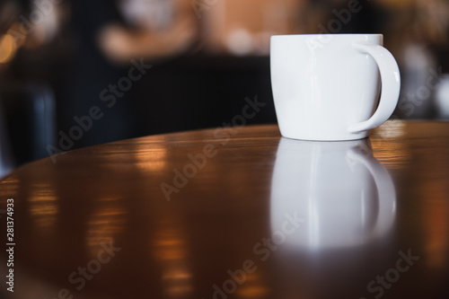cup of coffee on wooden table in coffee shop with copy space