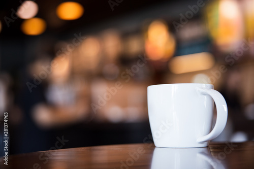 cup of coffee on wooden table in coffee shop with copy space