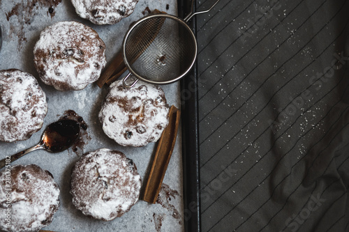 Rasins muffins with powdered sugar and cinamon. Cooking pastry. Tasty sweet cakes. photo