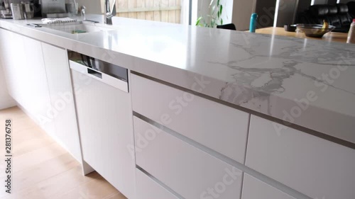 Woman closing kitchen drawer with soft close feature