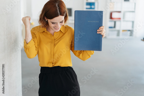 Slika na platnu Exultant young woman celebrating getting a job