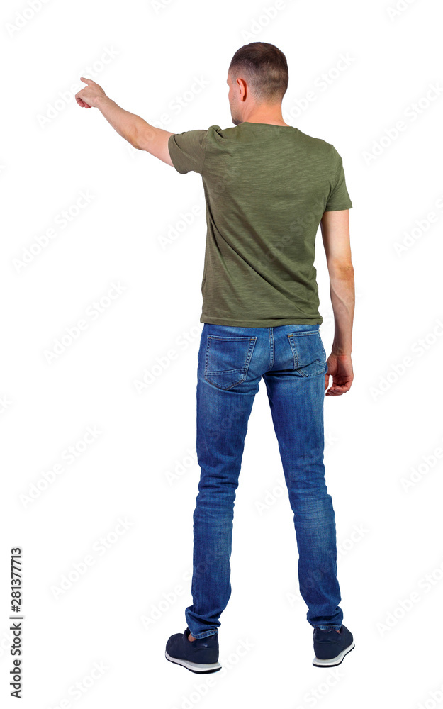 Back view of a man in jeans points his hand upwards. Back view of a man in jeans points his hand upwards.