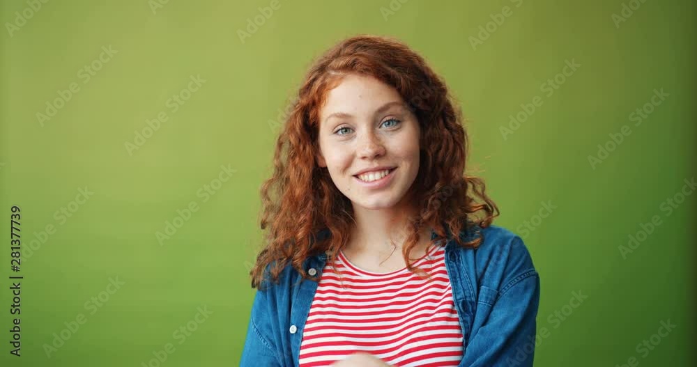 Portrait of pretty girl teenager showing call me gesture and smiling standing alone on green background gesturing. People, communication and youth concept. Portrait of pretty girl teenager showing call me gesture and smiling standing alone on green background gesturing. People, communication and youth concept.
