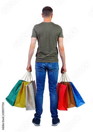 back view of man in shirt with shopping bags.