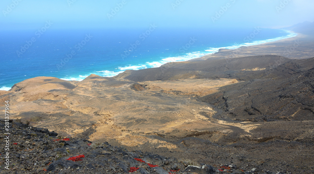 Long White Sand Beach on the Volcanic Landscape of Fuerteventura
