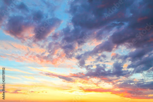 Heavenly summer background. Beautiful bright majestic dramatic evening sky at sunset or sunrise orange and blue with rays. The sun shines over the horizon against the backdrop of thunder clouds © Светлана Евграфова