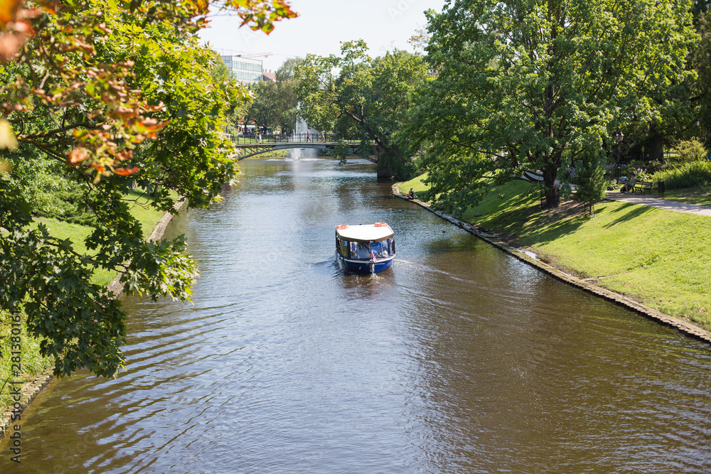 City Riga, Latvian Republic. A tourist boat flies through the canal.2019. 24. July. City Riga, Latvian Republic. A tourist boat flies through the canal.2019. 24. July.