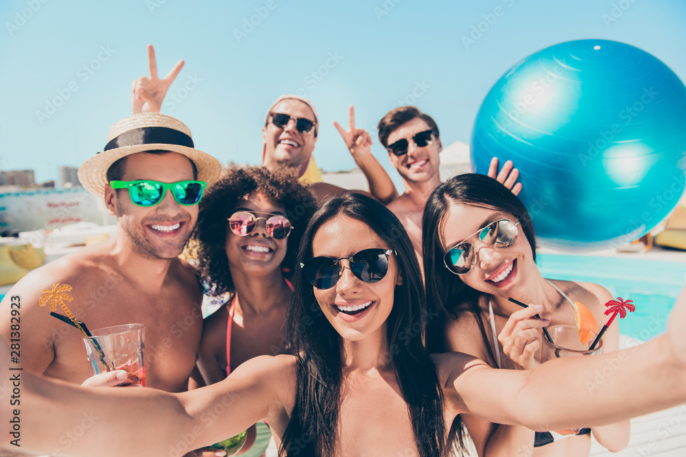 Close up photo of cute funny students with brunet hair wearing eyeglasses eyewear holding balloon making photos moments v-signs on journey outdoors