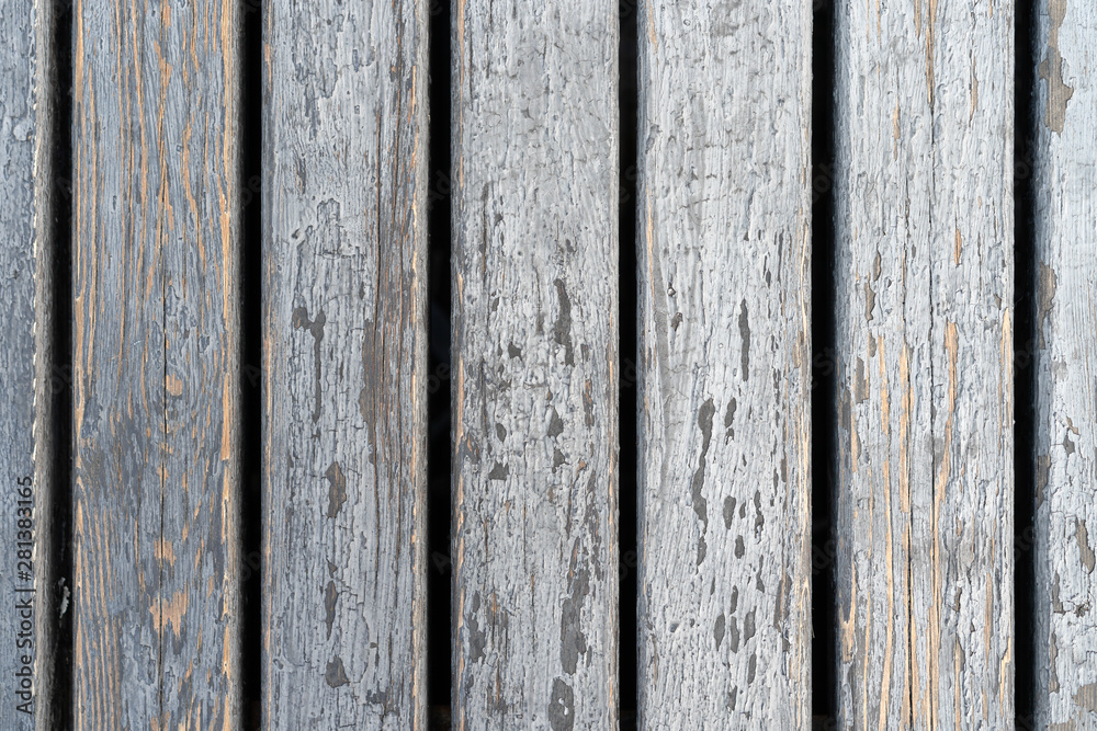 Old gray wooden panels. Granary board Peeled wood panels with gaps between them. Background.