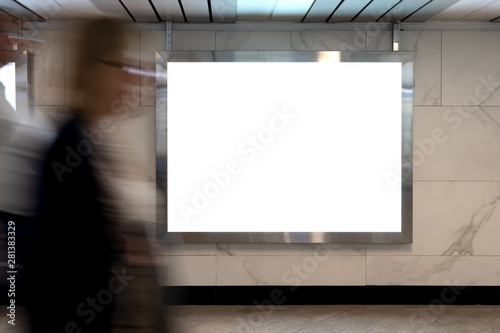 Mock up lightbox in underpass. Blurred movement people against background lightbox layout. Advertising in tunnel, transition.