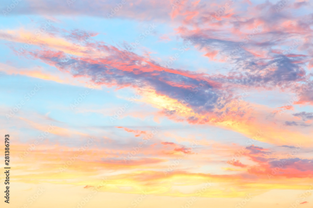 Heavenly abstract summer gentle background. Beautiful picturesque bright majestic dramatic evening morning sky at sunset or dawn in orange and blue in pastel colors. The sun rises on a warm day