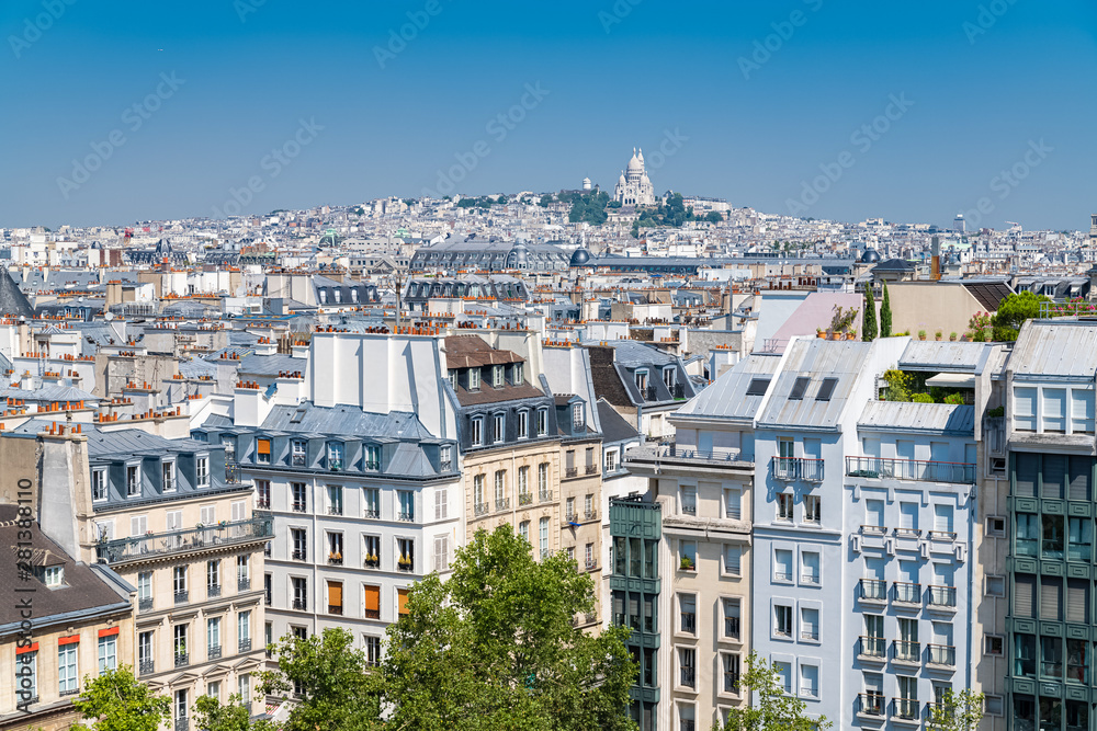 Paris, panorama of the city, typical roofs and buildings, with Montmartre and the Sacre-Choeur basilica in background