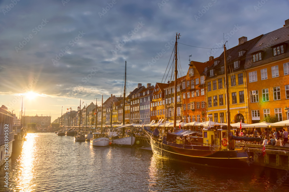 Copenhagen iconic view. Famous old Nyhavn port in the center of Copenhagen, Denmark during sunset