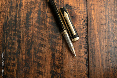 Old pen on wooden table