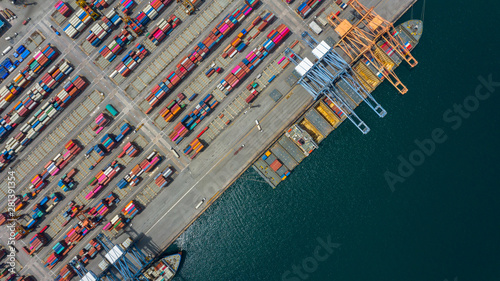 Aerial view cargo ship terminal, Unloading crane of cargo ship terminal, Aerial view industrial port with containers and container ship.