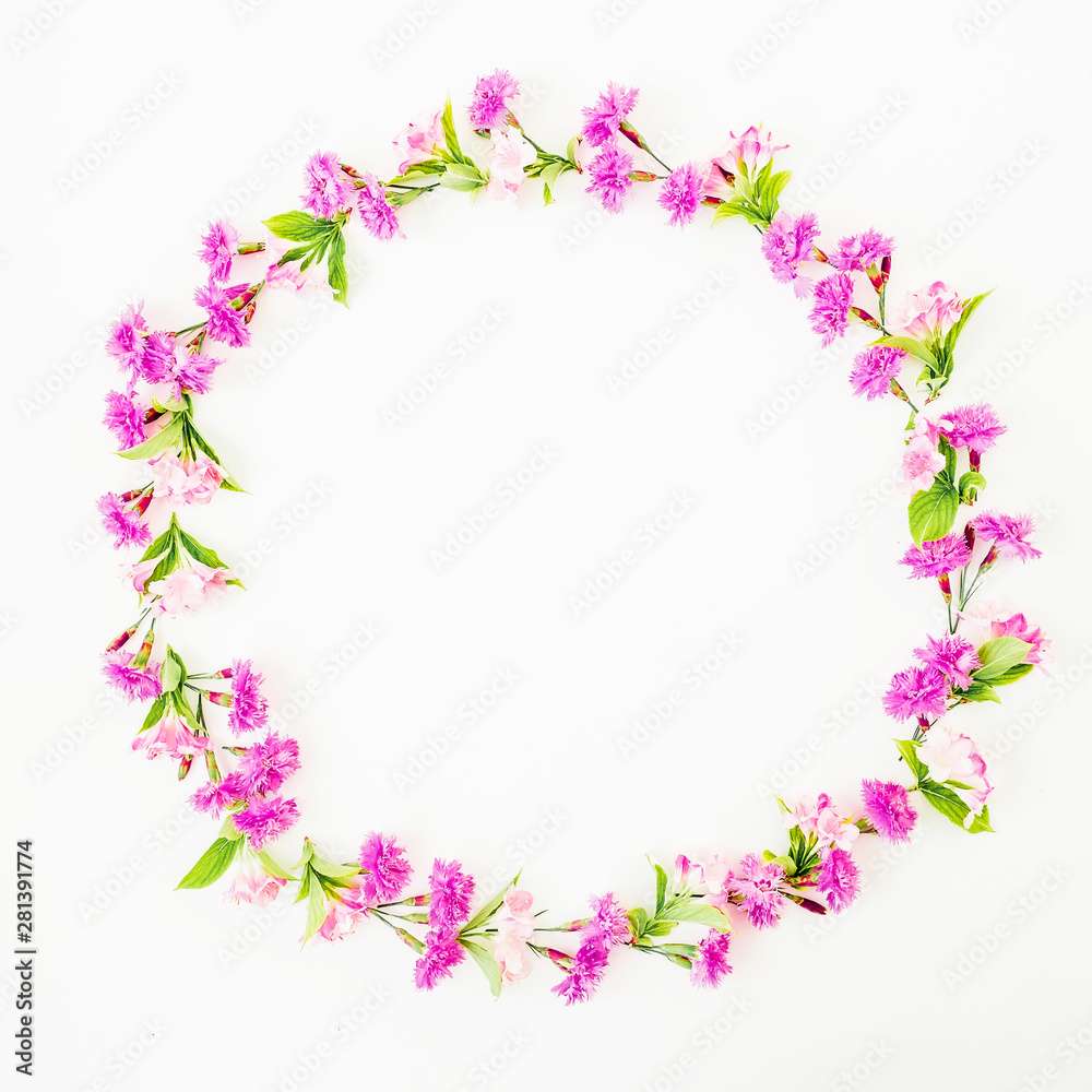 Round frame of pink flowers on white background. Flat lay, Top view