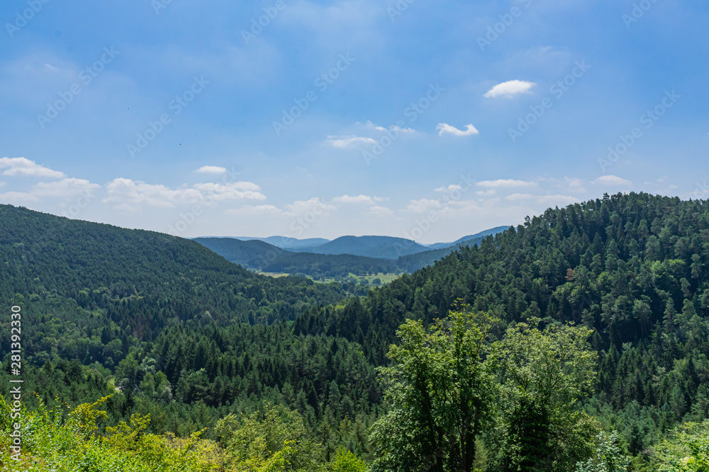 View over forests and hills with blue sky