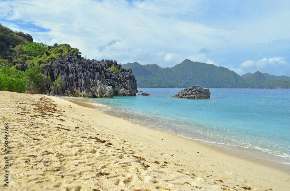 Nature landscape: Sandy tropical beach with crystal clear sea. Rocks and tropical beach.