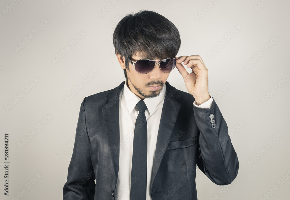 Portrait Businessman in Black Suit Touching Eyeglasses on Center Frame in Vintage Tone Portrait Businessman in Black Suit Touching Eyeglasses on Center Frame in Vintage Tone