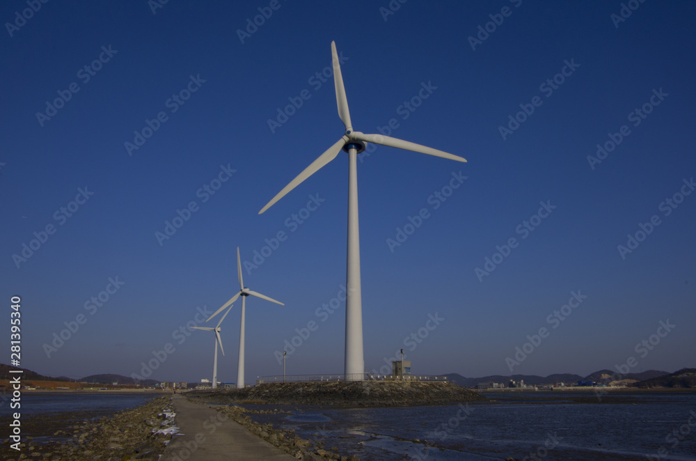 eco-friendly wind turbines on blue sky