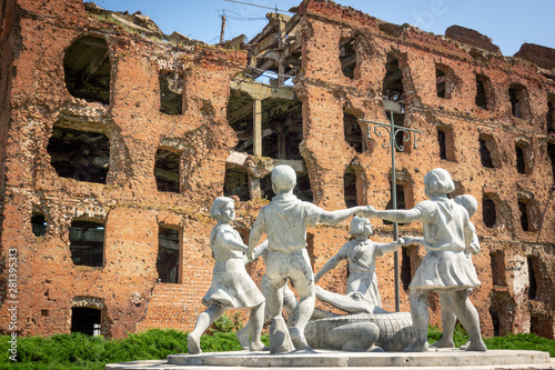 Volgograd/Russia-18.06.2016:The statue of with circle of kids and crocodile and destroyed building photo