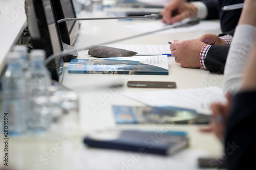 Group of businesspeople or lawyers discussing contract papers and financial figures while sitting at the table. Close-up of human hands  Success and communication concept