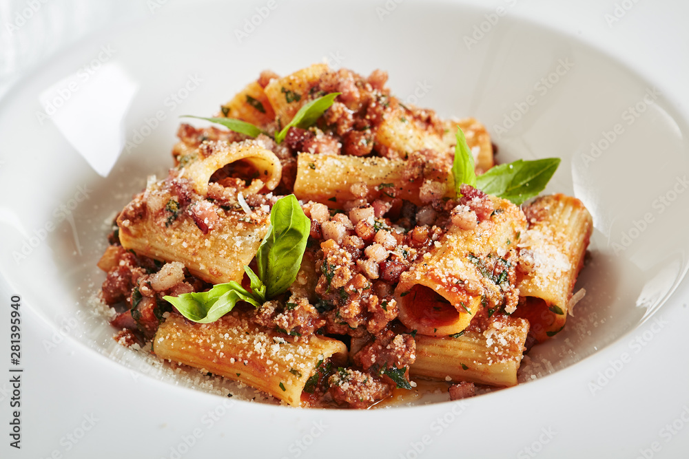 Exquisite Serving White Restaurant Plate of Homemade Rigatoni with Bolognese Sauce and Smoked Pork Belly Exquisite Serving White Restaurant Plate of Homemade Rigatoni with Bolognese Sauce and Smoked Pork Belly