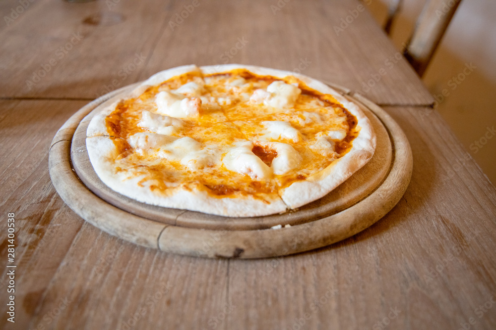 Home made Crispy Thin Cheese and Shrimp Pizza Hot Served on a wooden plate Placed on a wooden table. Home made Crispy Thin Cheese and Shrimp Pizza Hot Served on a wooden plate Placed on a wooden table.
