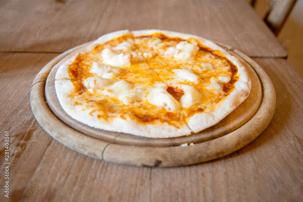 Home made Crispy Thin Cheese and Shrimp Pizza Hot Served on a wooden plate Placed on a wooden table. Home made Crispy Thin Cheese and Shrimp Pizza Hot Served on a wooden plate Placed on a wooden table.