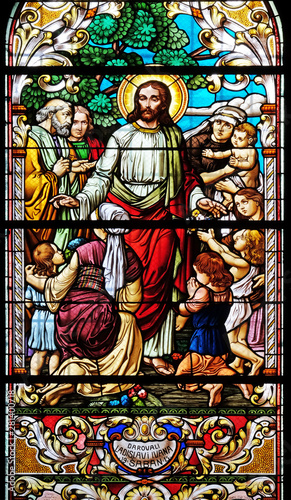 Jesus blesses mothers with children, stained glass window in the Saint John the Baptist church in Zagreb, Croatia