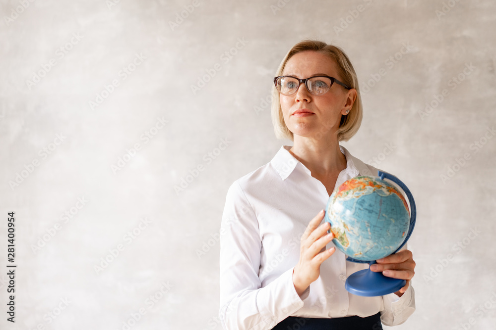 Charming teacher wearing blouse and skirt holds globe her hands Stock Photo  | Adobe Stock