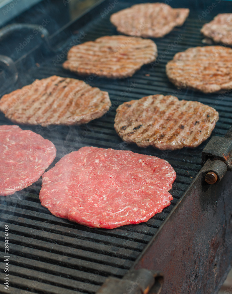 Street food. Fry meat patties (burgers) fresh beef on the grill Street food. Fry meat patties (burgers) fresh beef on the grill