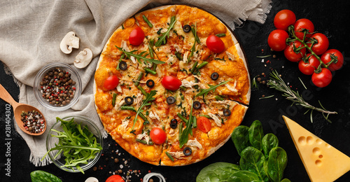 Pizza decorated with rocket salad and cherry tomatoes