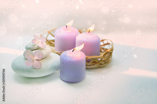 Beautiful composition with candles  flowers hydrangea  spa stones on white background. Spa therapy composition. Ritual for relaxation  meditation. copy space. shallow depth  selective focus