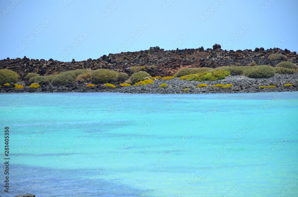 Naklejka premium Turquoise Ocean Water and a Volcanic Island in Canary Islands
