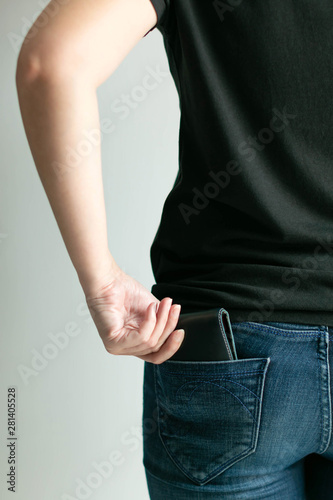 A woman bring out money wallet from jeans pocket. © jtas